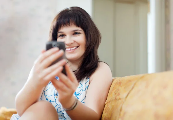 Happy woman reads SMS — Stock Photo, Image