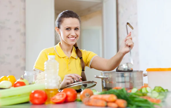 Woman cooking in saucepan — Stock Photo, Image