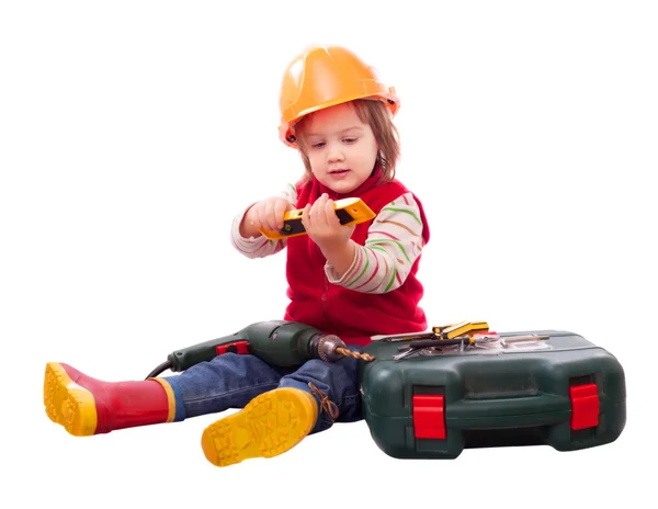 Child in builder hardhat with tools — Stock Photo, Image