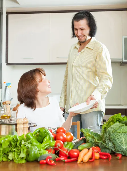 Un hombre atractivo y hermosa mujer con verduras en el kit —  Fotos de Stock