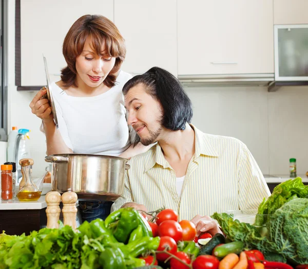 Flirting couple cooking together — Stock Photo, Image