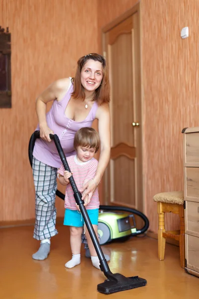 Family chores with vacuum cleaner in home