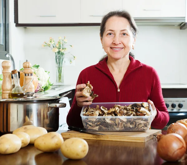 Mature woman with dried mushrooms — Stock Photo, Image