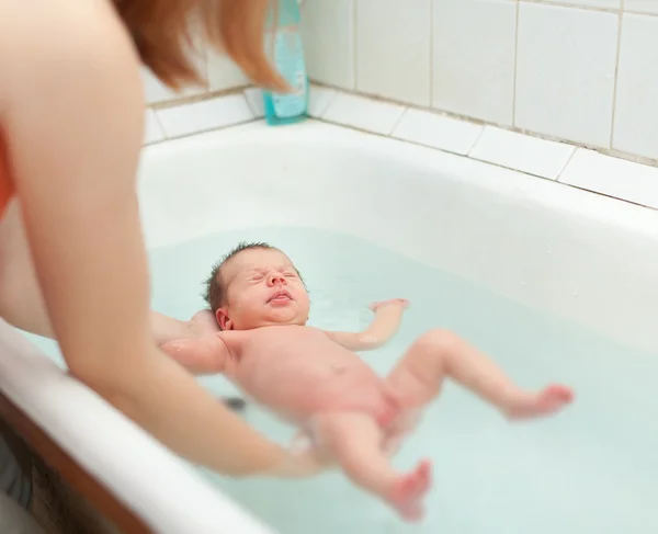 Mãe banha bebê recém-nascido — Fotografia de Stock