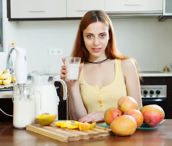 Donna che beve frullato di latte con mango — Foto Stock