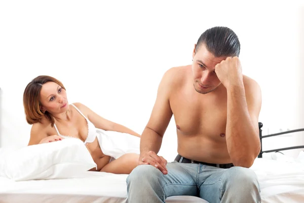 Woman consoling the depressed husband in bedroom — Stock Photo, Image