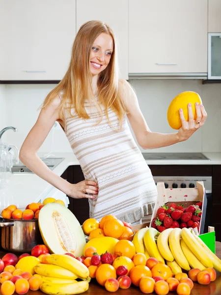 Long-haired woman with melon — Stock Photo, Image