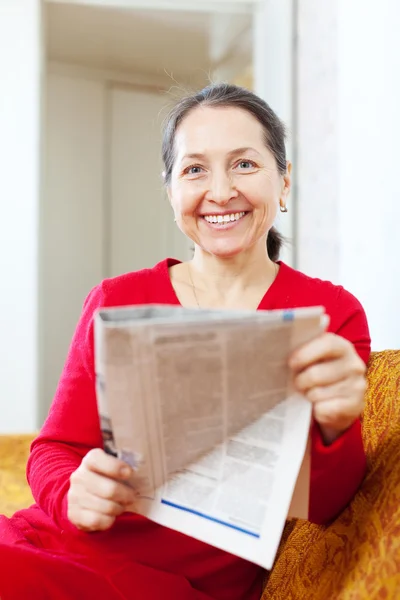 Joyful mature woman with newspaper — Stock Photo, Image