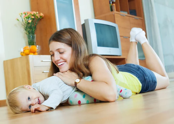 Máma a dítě na dřevěnou podlahu — Stock fotografie