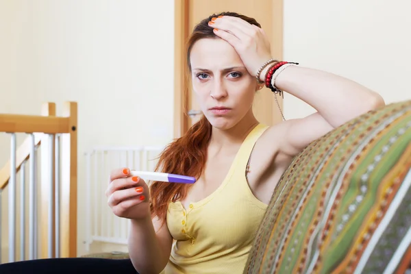 Unhappy girl with pregnancy test — Stock Photo, Image