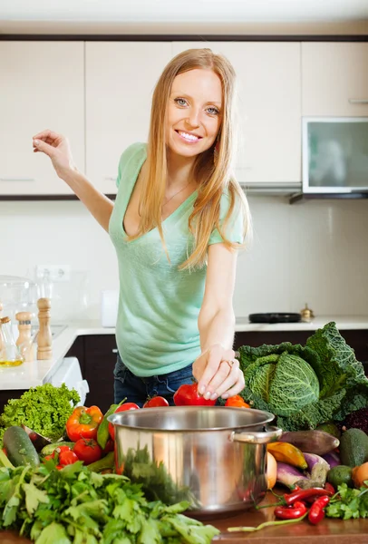 Woman cooking from raw vegetables in home Royalty Free Stock Images