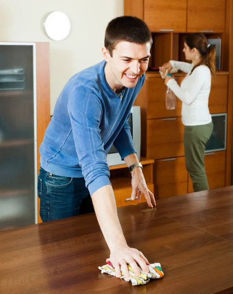 Man with wife dusting furniture — Stock Photo, Image