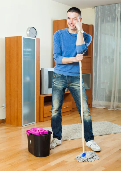 Smiling man   with mop — Stock Photo, Image