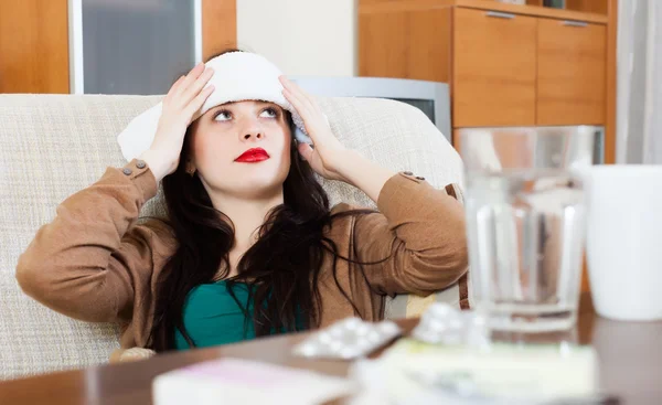 Suffering woman  stuping  towel to  head — Stock Photo, Image