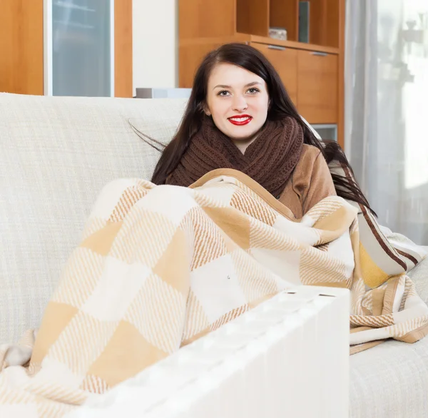 Woman warming near electric heater — Stock Photo, Image