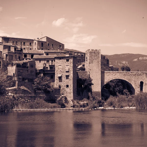 Retro photo of medieval fortifications and bridge — Stock Photo, Image