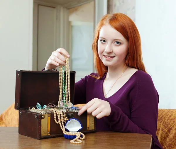 Teenager girl looks jewelry — Stock Photo, Image