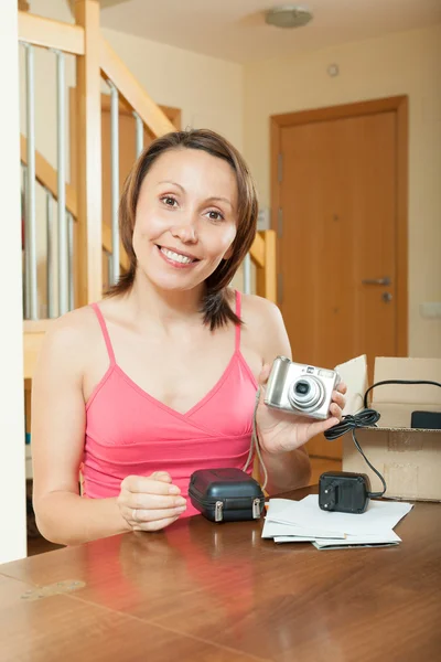 Menina desembalagem nova câmera digital compacta — Fotografia de Stock