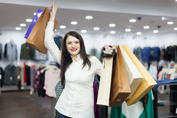 Girl with shopping bags at clothing store — Stock Photo, Image