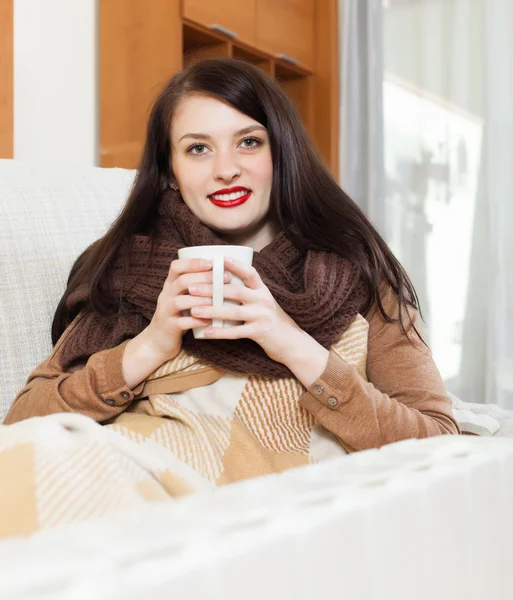 Happy girl with cup near calorifer — Stock Photo, Image