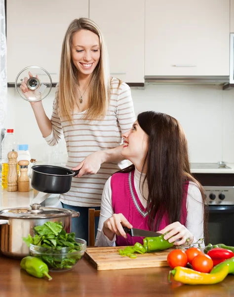 Lachende meisjes koken thuis — Stockfoto