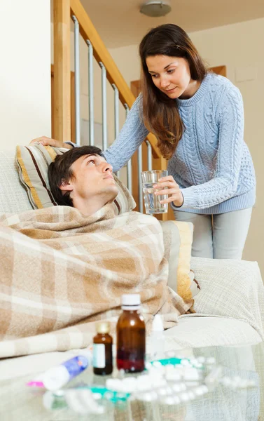 Girl caring for sick husband — Stock Photo, Image