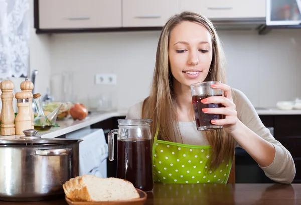 Woman   with brown beverage in glass — Stock Photo, Image