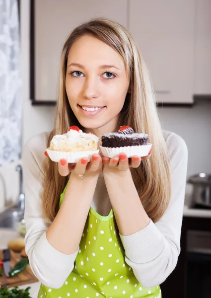 Lächelnde Frau in Schürze mit Kuchen — Stockfoto