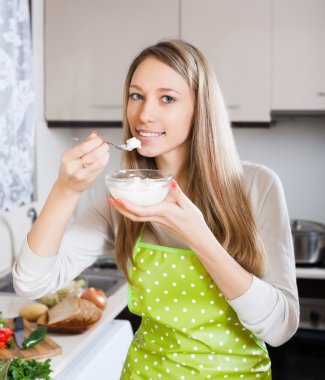 woman eating cottage cheese clipart