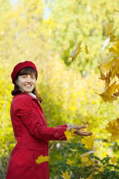 Young woman throwing  maple leaves — Stock Photo, Image