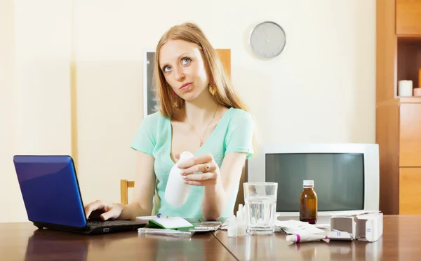 Woman reading about medications — Stock Photo, Image