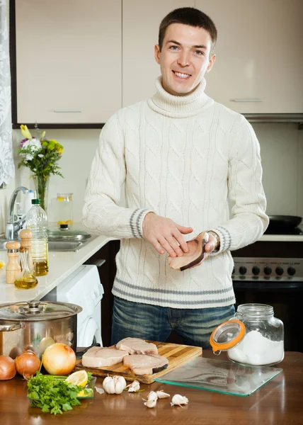 Handsome man cooking steak of fish — Stock Photo, Image