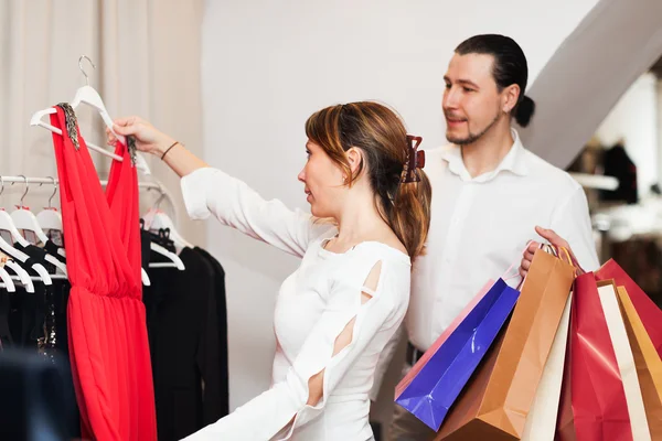 Casal escolhendo vestido na boutique — Fotografia de Stock