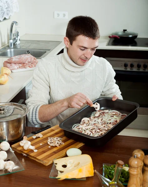 Guy cooking french-style meat — Stock Photo, Image
