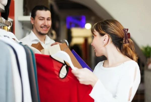 Mężczyzna i kobieta wybierając ubrania w sklepie — Zdjęcie stockowe