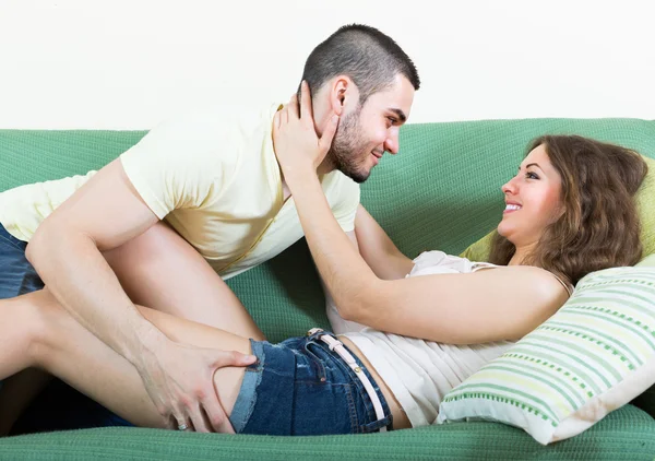 Loving couple on sofa — Stock Photo, Image