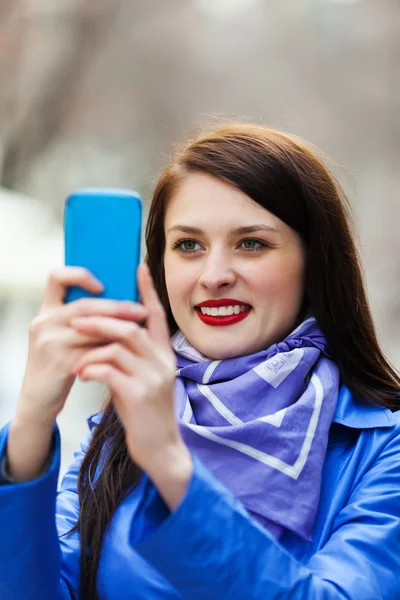 Девушка со смартфоном фотографирует — стоковое фото