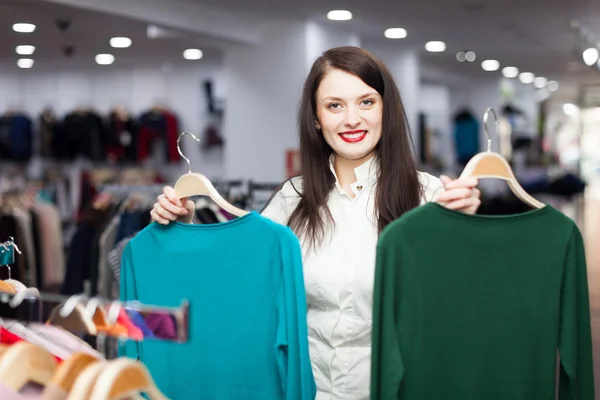 Young female buyer with sweaters Stock Image