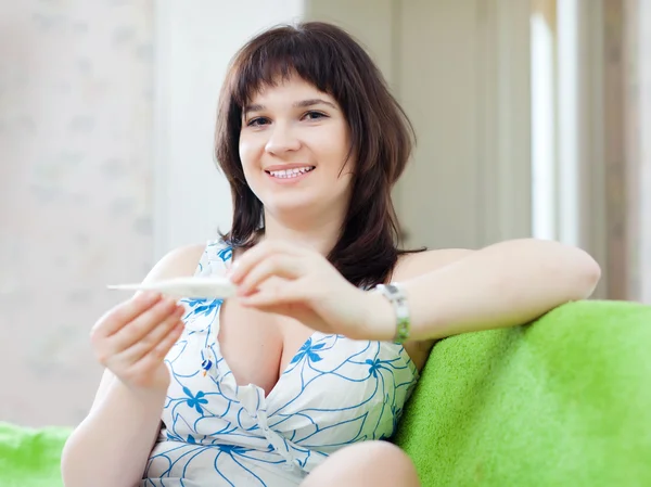 Woman looks by thermometer — Stock Photo, Image