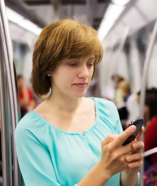 Mujer usando smartphone en metro — Foto de Stock