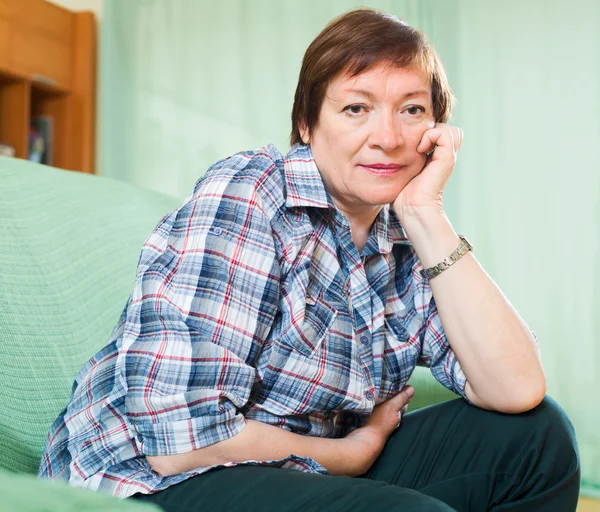 Stressed female pensioner on couch — Stock Photo, Image