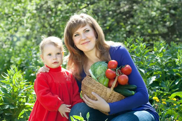 Happy woman and baby girl with vegetables — Stock Photo, Image