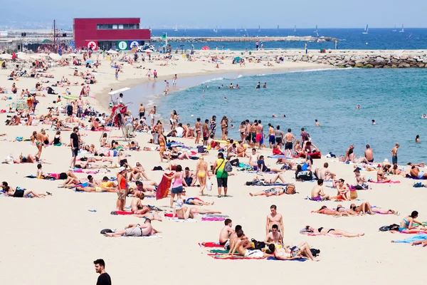 Bain de soleil pour les vacanciers à la plage de Bogatell — Photo