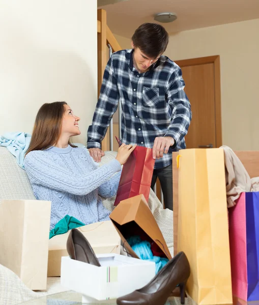 Woman showing purchases  to  boyfriend — Stock Photo, Image