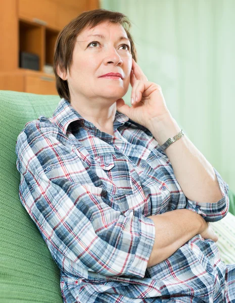 Stressed female pensioner on couch — Stock Photo, Image