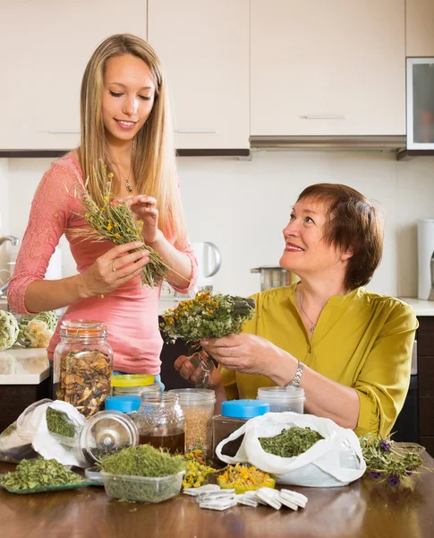 Two women with dried herbs — Stock Photo, Image