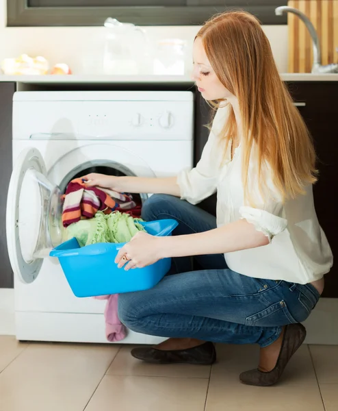 Женщина с помощью стиральной машины — стоковое фото