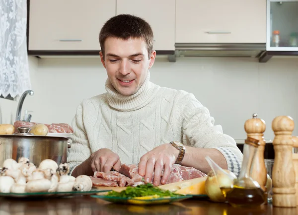 Guy cooking french-style meat — Stock Photo, Image