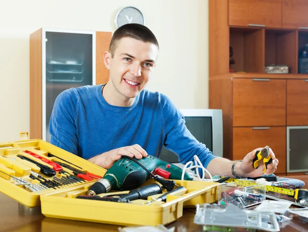 Feliz hombre sonriente organizando caja de herramientas —  Fotos de Stock