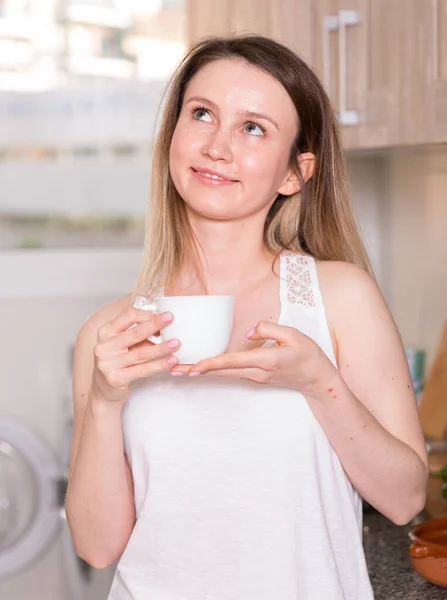 Portrait of cheerful female who is playful posing with tea — Stock Photo, Image